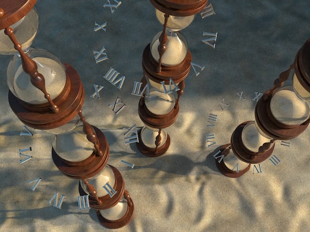 Three tall hourglasses rest on the sand with roman numerals lightly imposed in the background