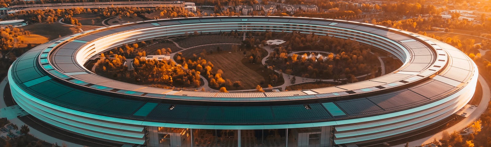 IMAGE: A picture of Apple’s headquarters circular building in a sunset