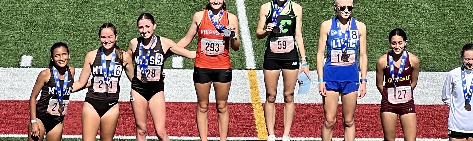 The top eight finishers at the California Community College Track meet stand on the medal podium where my daughter finished in sixth place.