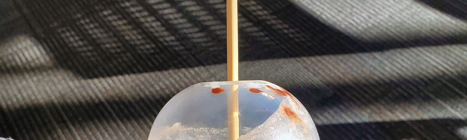 A Starbucks Frappuccino with a chopstick in the middle, where a straw should be.