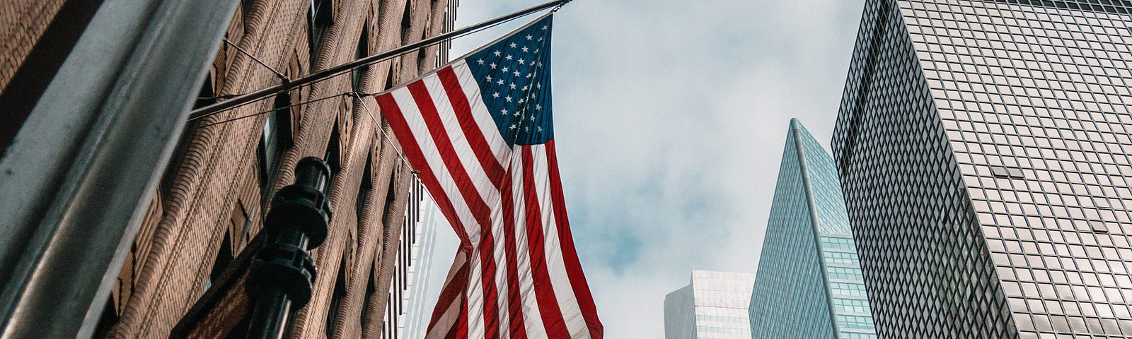 Photo of the flag of U.S.A on a skyscraper