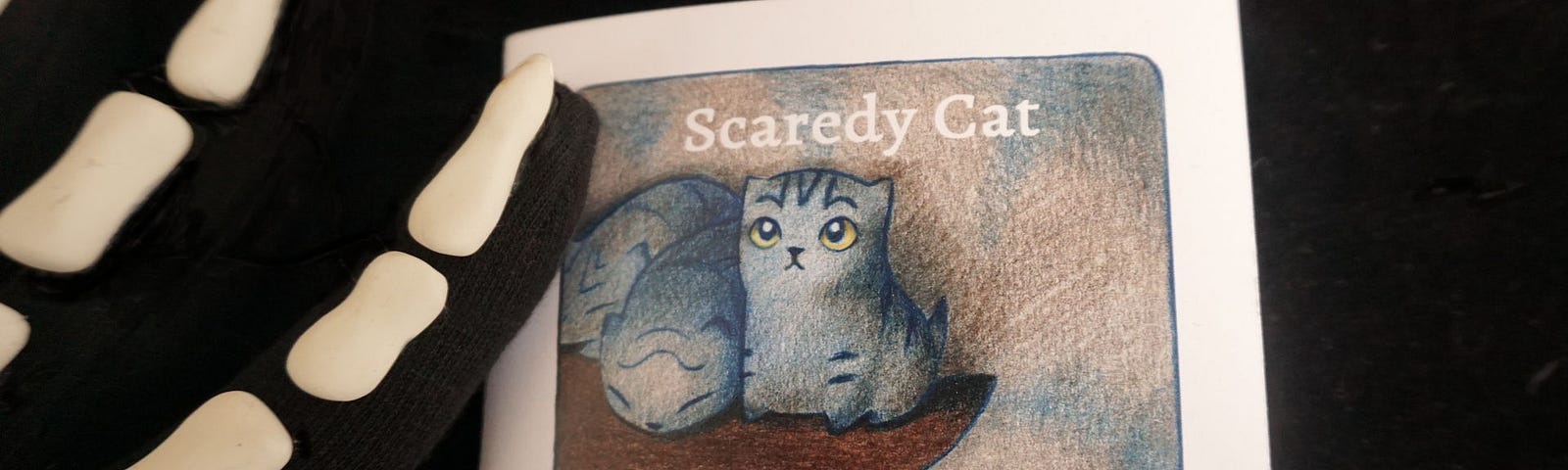 photograph of the front cover of a tiny book: Scaredy Cat by Heather Franzen