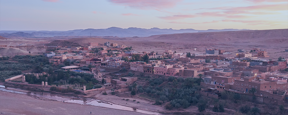 Image shows a picture of Marrakesh in Morocco with a river with very low flow