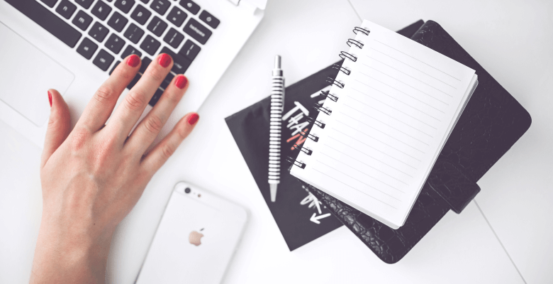 Designer’s hand with a notepad