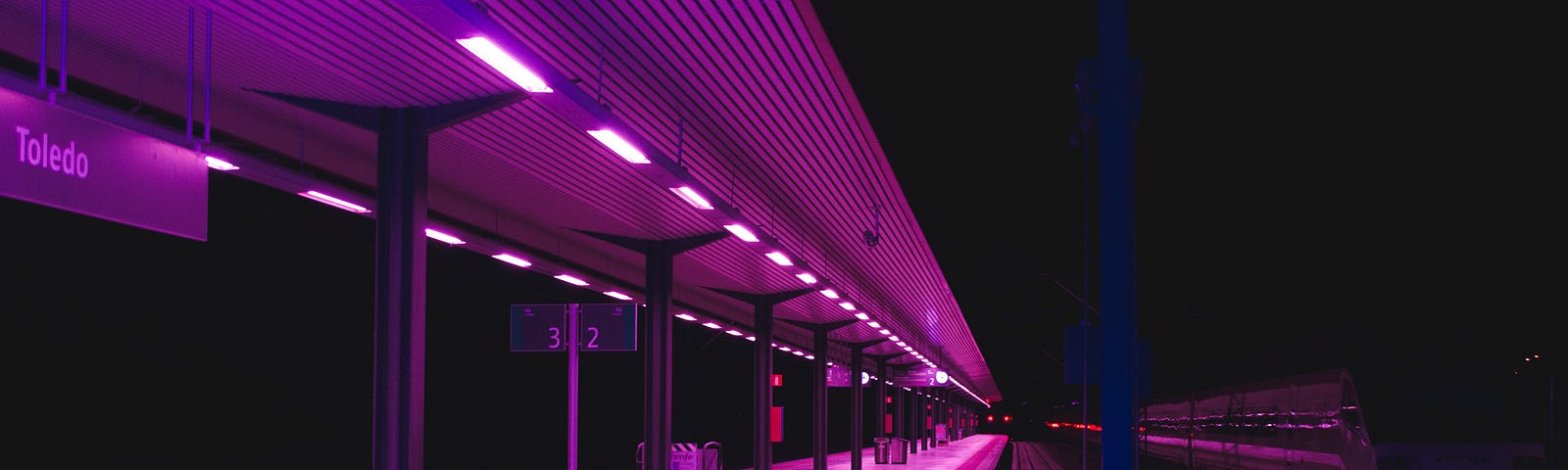 A train station platform at night