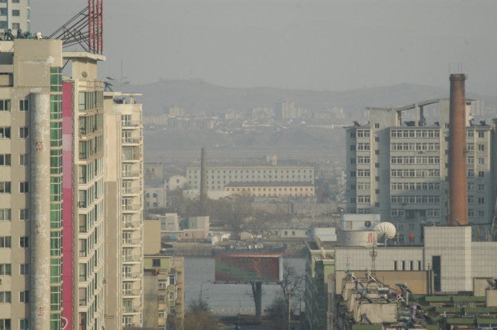 North Korea visible passed a river, lots of factories and barren hills. view from my apartment window.