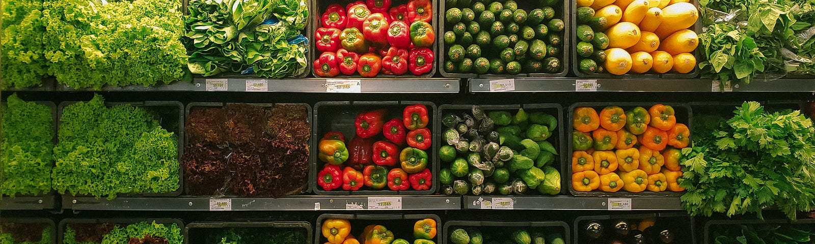 A supermarket produce shelf stocked with vegetables including lettuce, capsicum, zucchini, eggplant and pumpkin. Photo: nrd on Unsplash