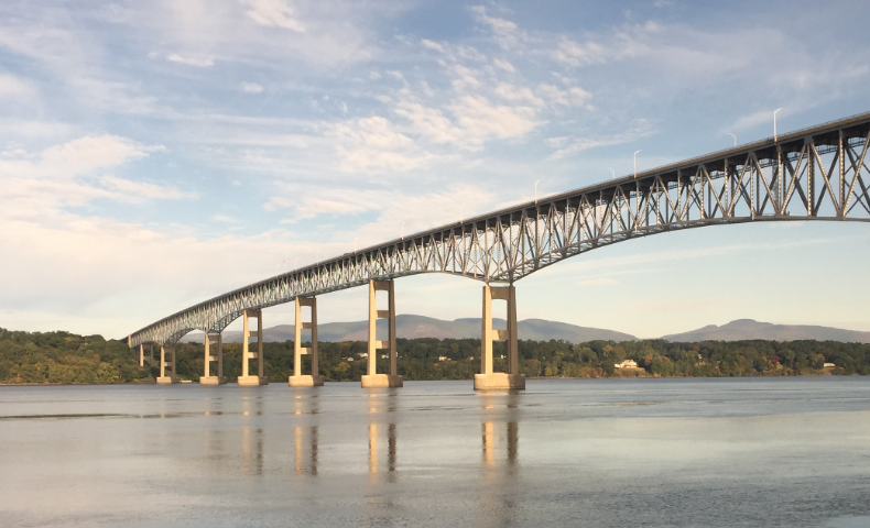 A long trestle bridge crossing a wide river