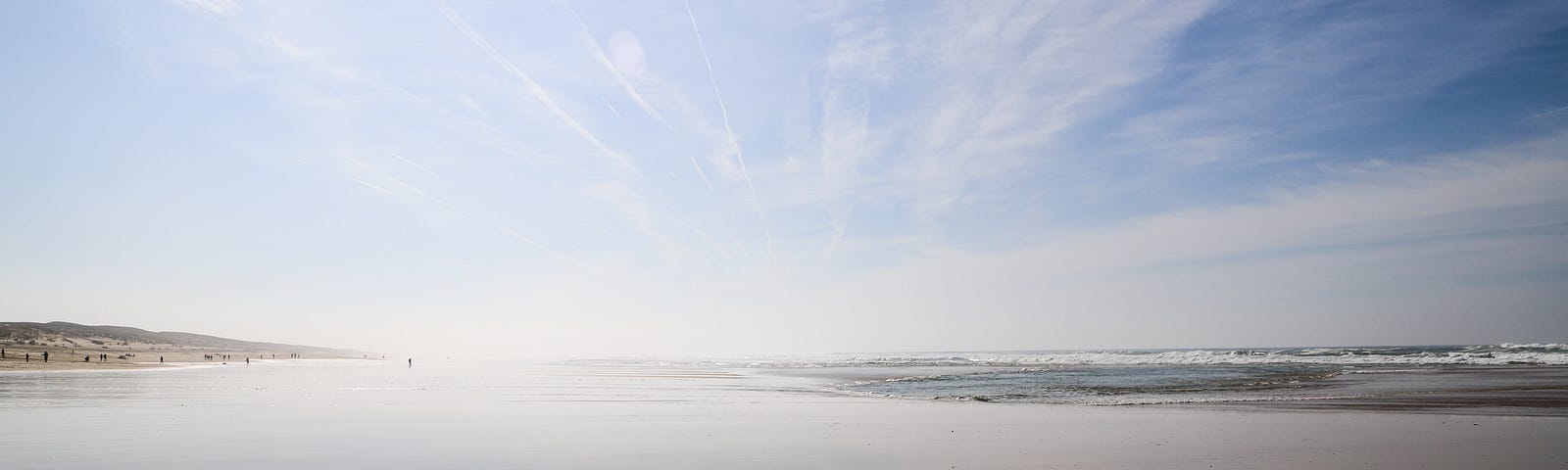 beach and sky with clouds streaking towards the vanishing point.