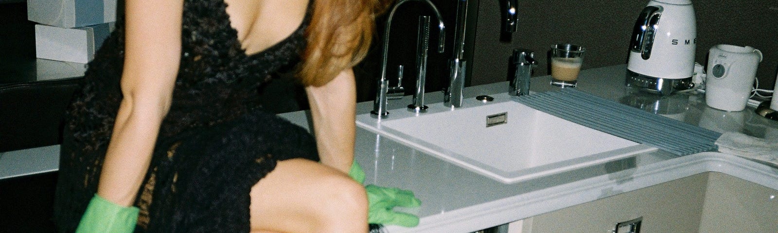 Glamourous lady in dish gloves sitting on counter beside open dishwasher, glamourous life, the luxury kitchen gadget I can't live without, salad, salad spinner, salad spinner review, lettuce, salad blends, food poisoning, avoid food poisoning, listeria, salmonella, ecoli, clean food, wash vegetables, casey lane, caseylanewords, medium, medium article, black dress, sunglasses, evening gown