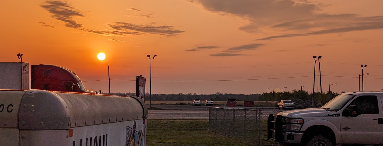 Sunrise over a uhaul trailer in the flat lands of oklahoma at a gas station