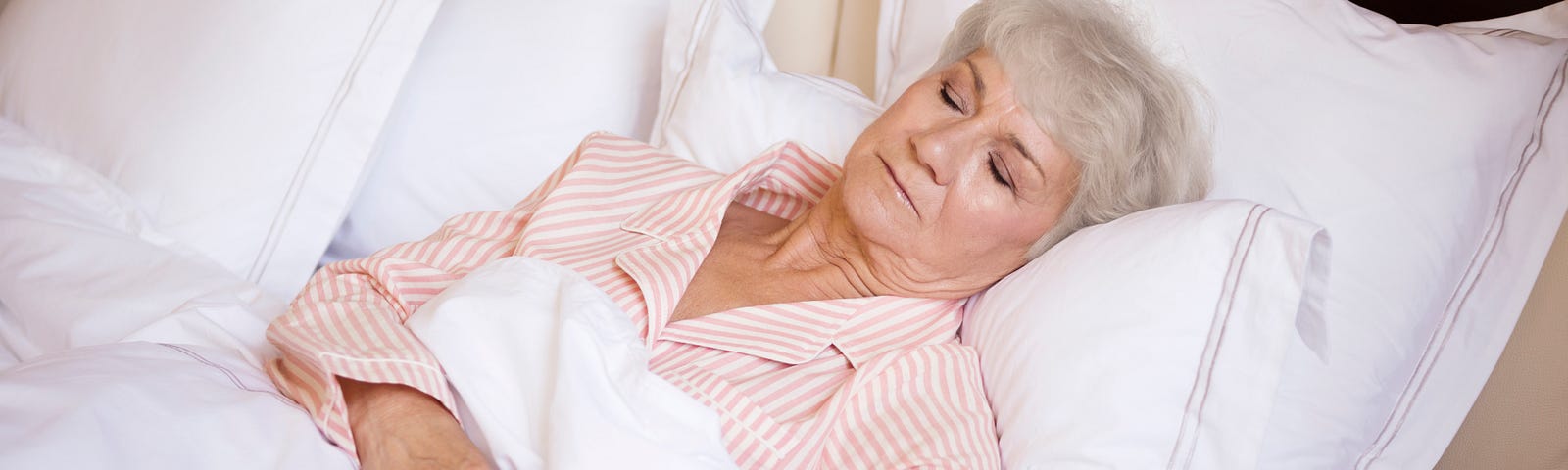 Elderly woman sleeping in bed