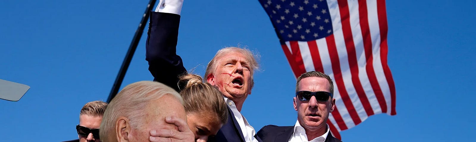 Donald Trump pumping his fist in front of an American flag after being shot. Supermimposed under him is Biden with his hand on his face pointing somewhere.