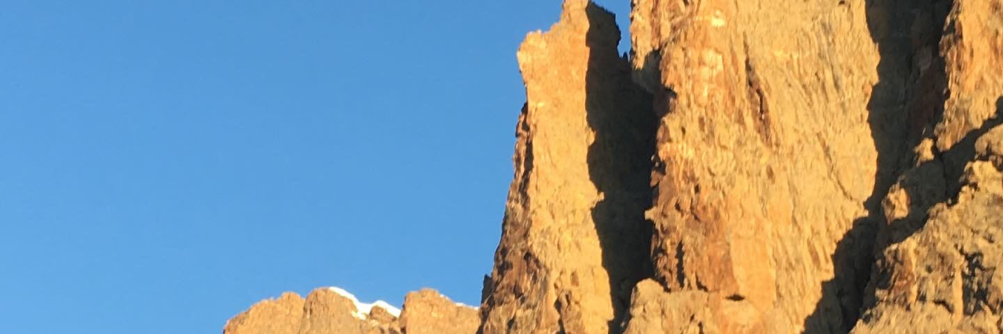 Petit Grepon Rocky Mountain National Park Rock Climb in dawn sunlight with snow June