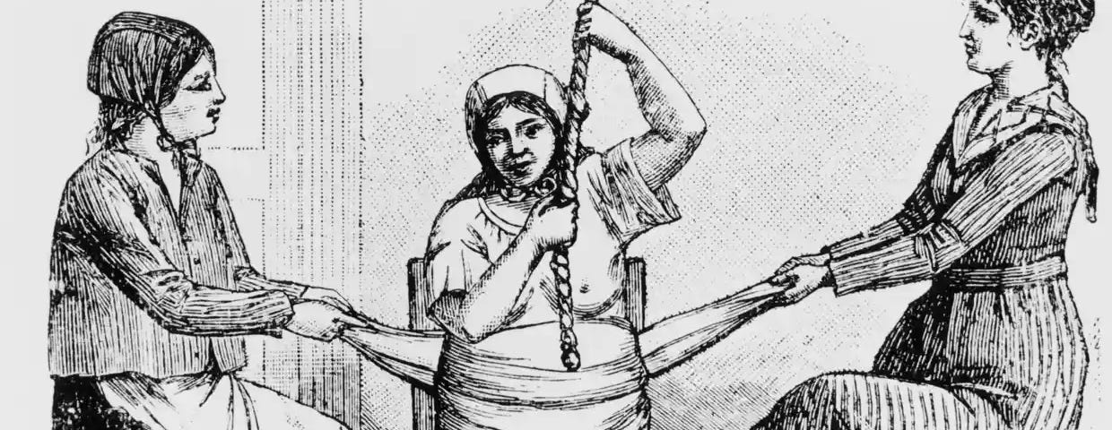 A woman in labour, while two midwives pull on a cloth tied around her belly. Image from California (1800s)