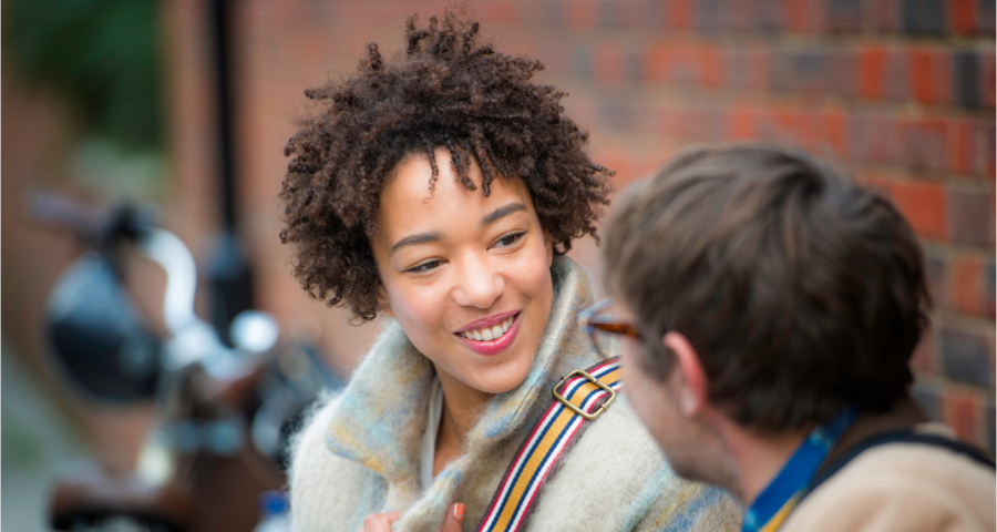 Image of a woman warmly talking to a friend.