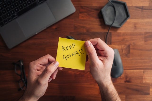 Yellow post-it note that says, “Keep Going!”