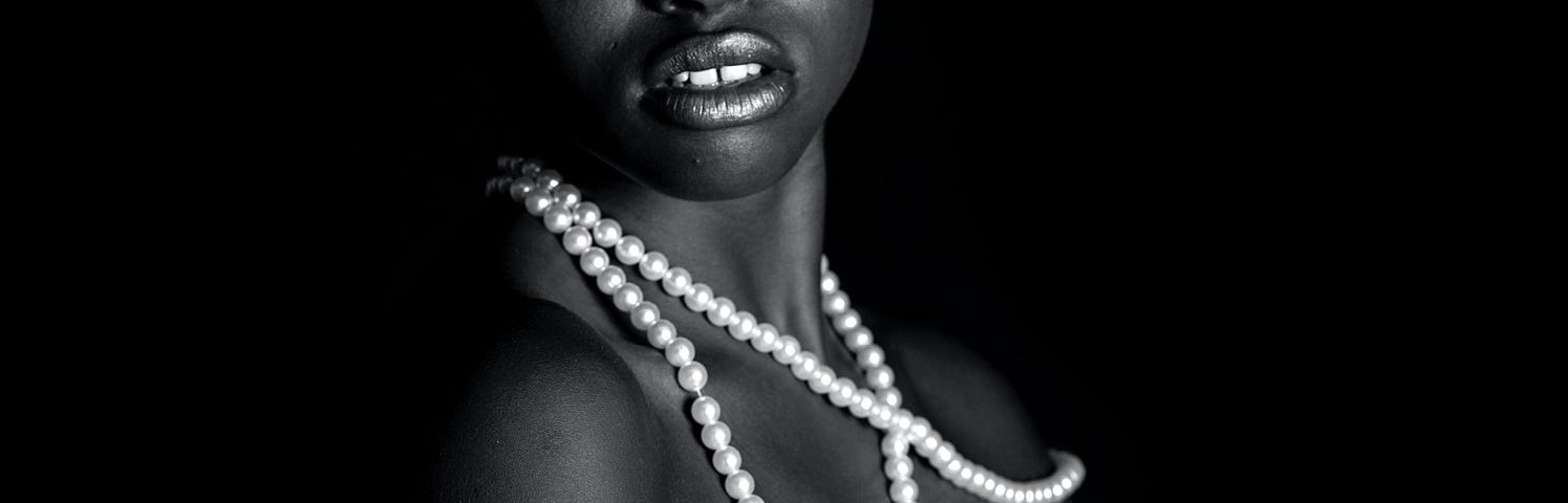 A beautiful woman of colour wearing pearls