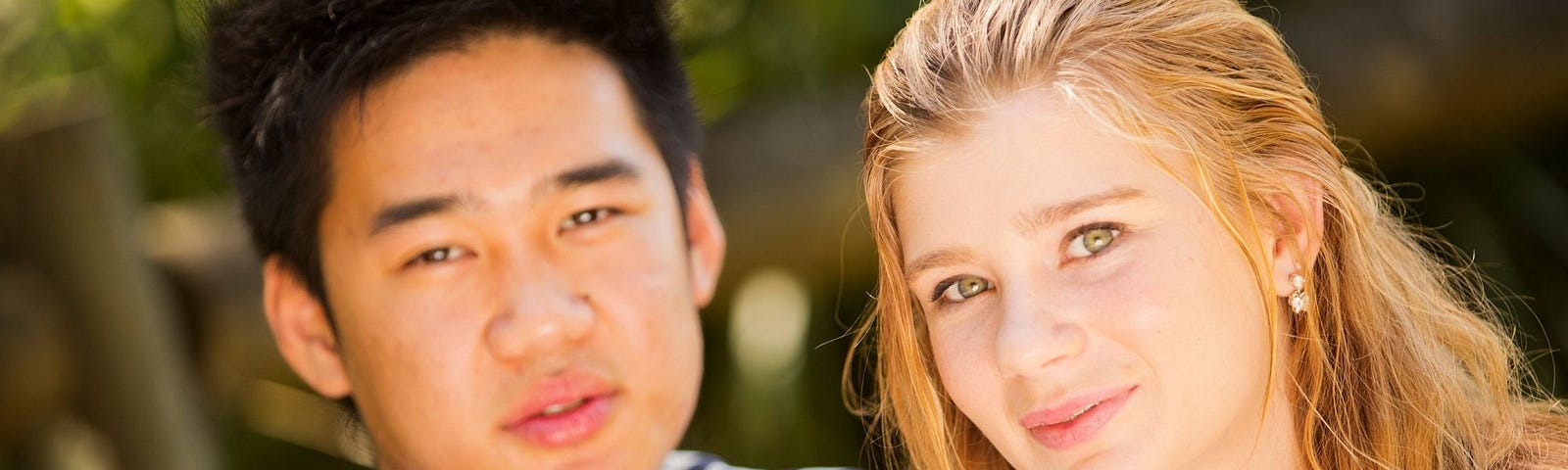 An interracial couple — an Asian man with a white woman
