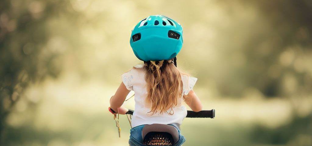 a young girl riding her bike, Dear Daughter, Don’t Stare at the Obstacle — Look at Where You Want to Go