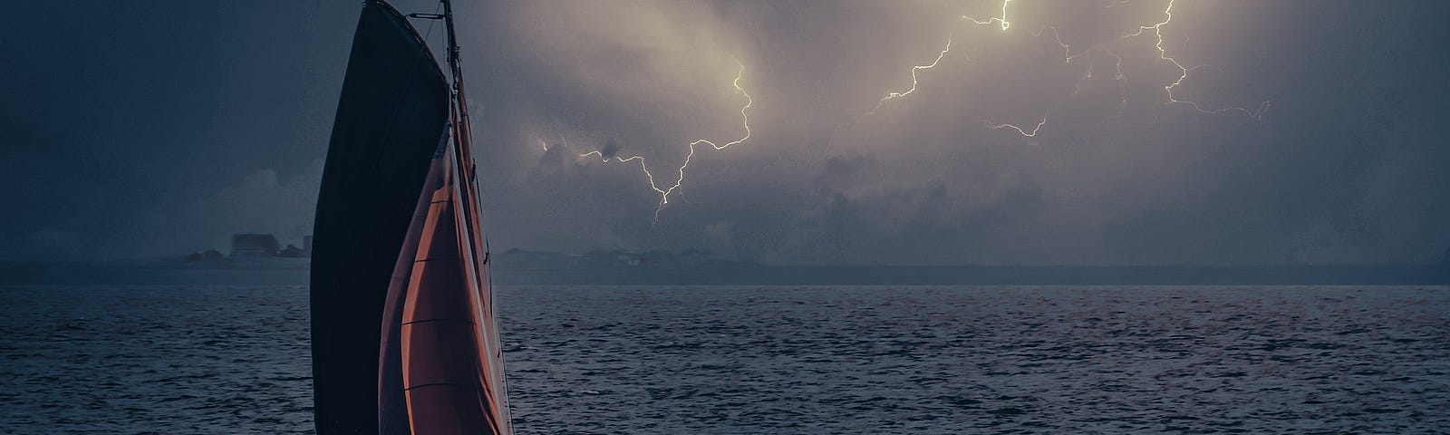 Sailboat sailing ahead of a thunderstorm