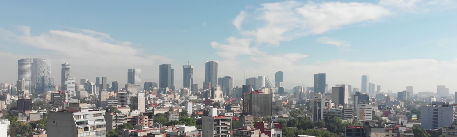 Aerial view of the Skyline in Mexico City, flying over Parque México