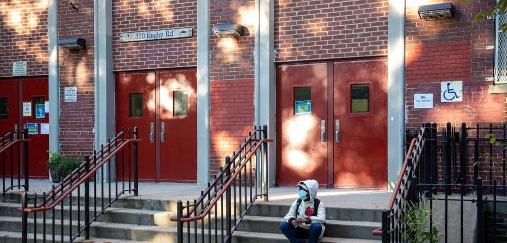 A student is seen on the steps of the closed public school PS 139 in the Ditmas Park neighborhood in Brooklyn of New York.