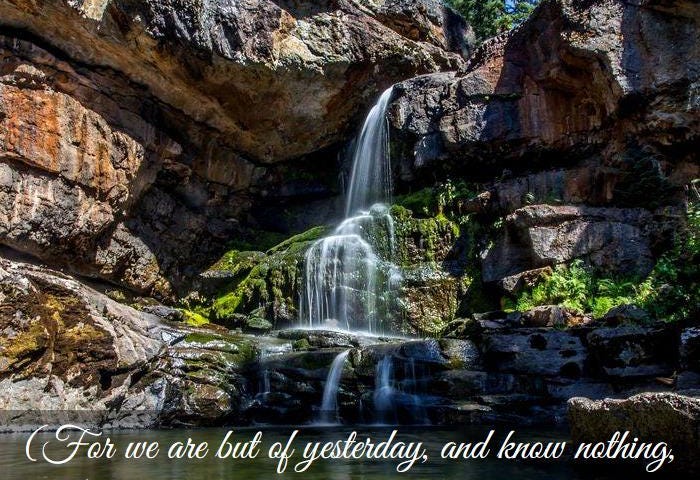 Waterfalls over large boulders.