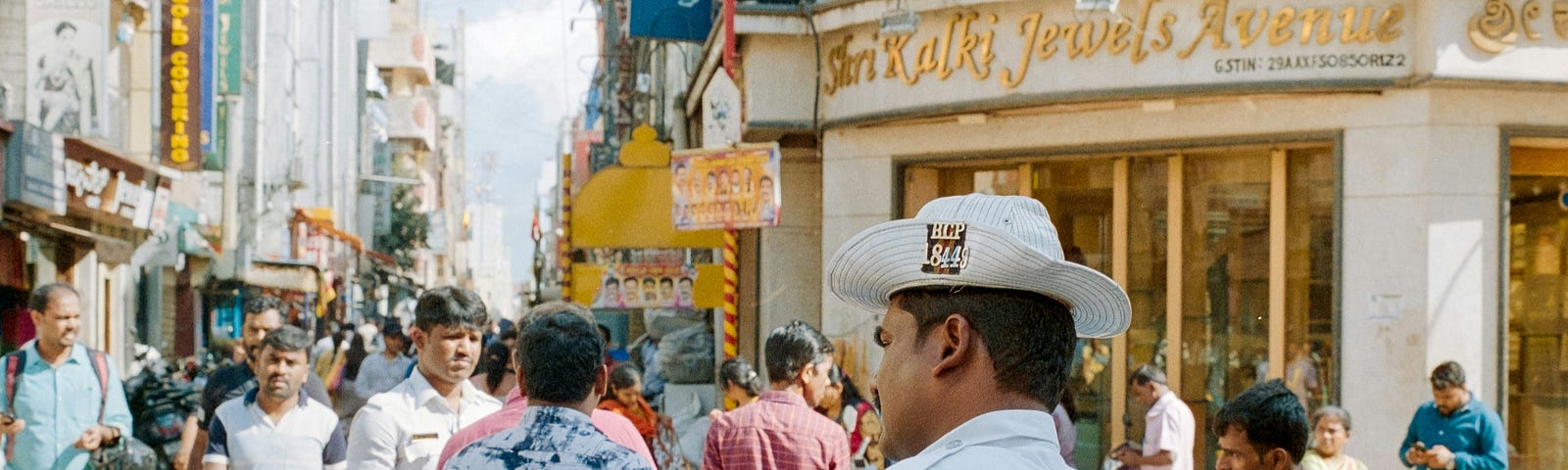 A traffic policeman in the middle of a chaotic and vibrant street in Bengaluru