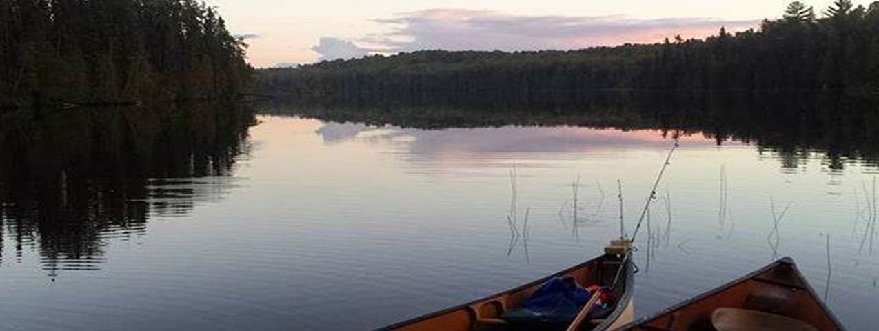 Two Canoes on a glassy water IMAGE by Rick Rice Duluth MN