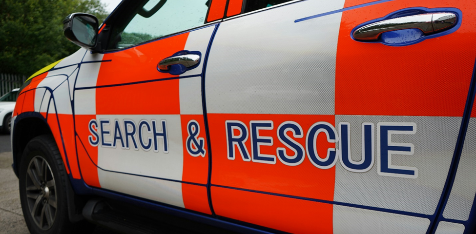 Brightly colored first responder vehicle with “Search & Rescue” on the doors.