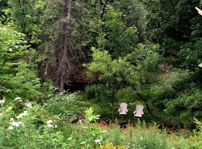 A photo of 2 chairs by a stream in Duluth, Minnesota.