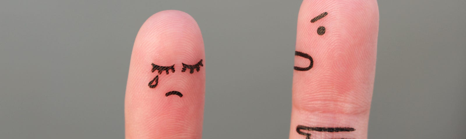 Two fingers, drawn on to represent to people. One is standing meekly, while the other is pointed and shouting instructions at them.