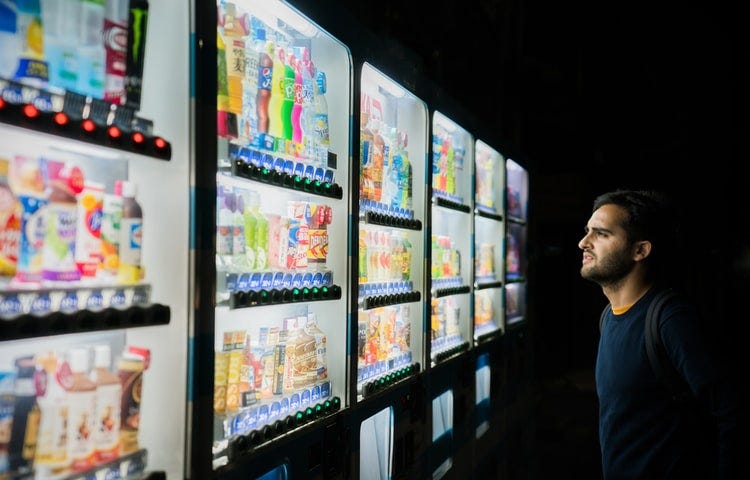 A man standing in front of soda drinks — not having freedom to choose helps you synthesize happiness