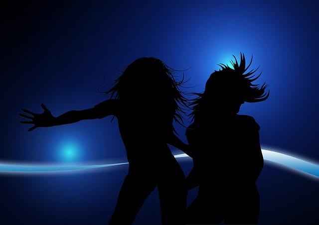 Women dancing, blue background, lights, movement
