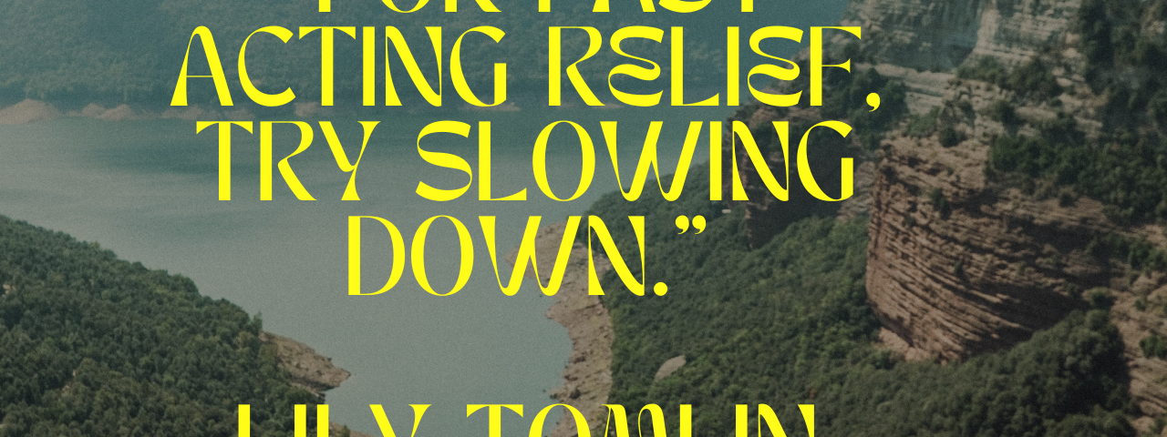 2 women on cliff of mountains with quote: “For fast acting relief, try slowing down.” Lily Tomlin