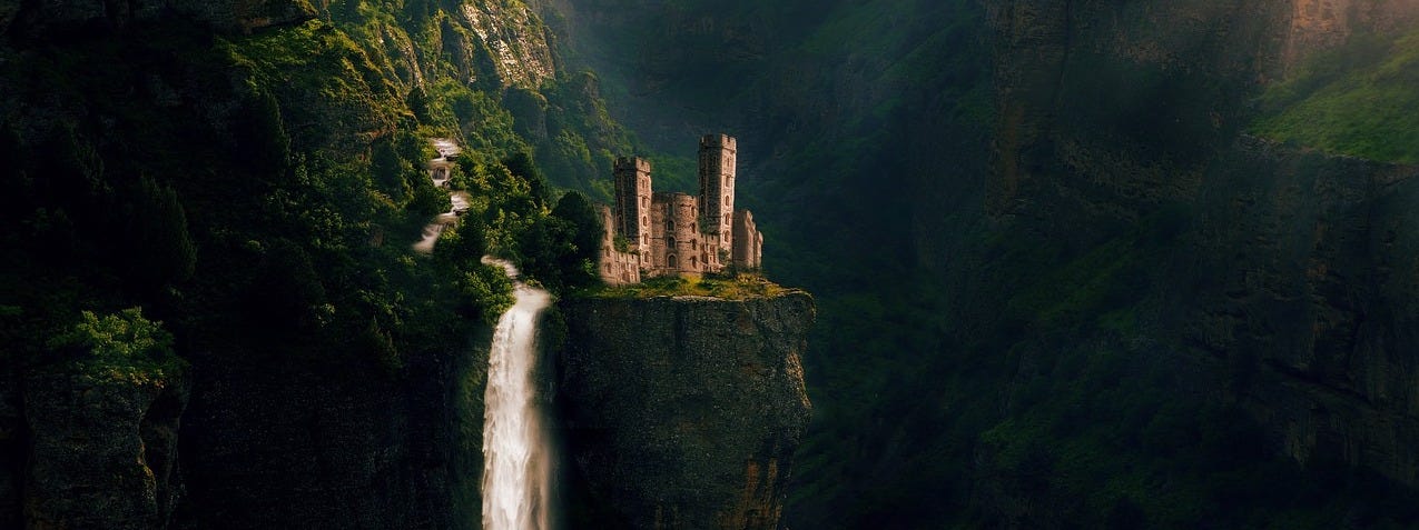 A fairytale castle sitting on a cliffside with a waterfall running beside it.