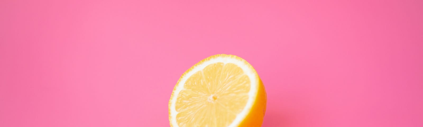 Lemon on pink background | an introduction to the simple pleasures publication | medium | avigail laing