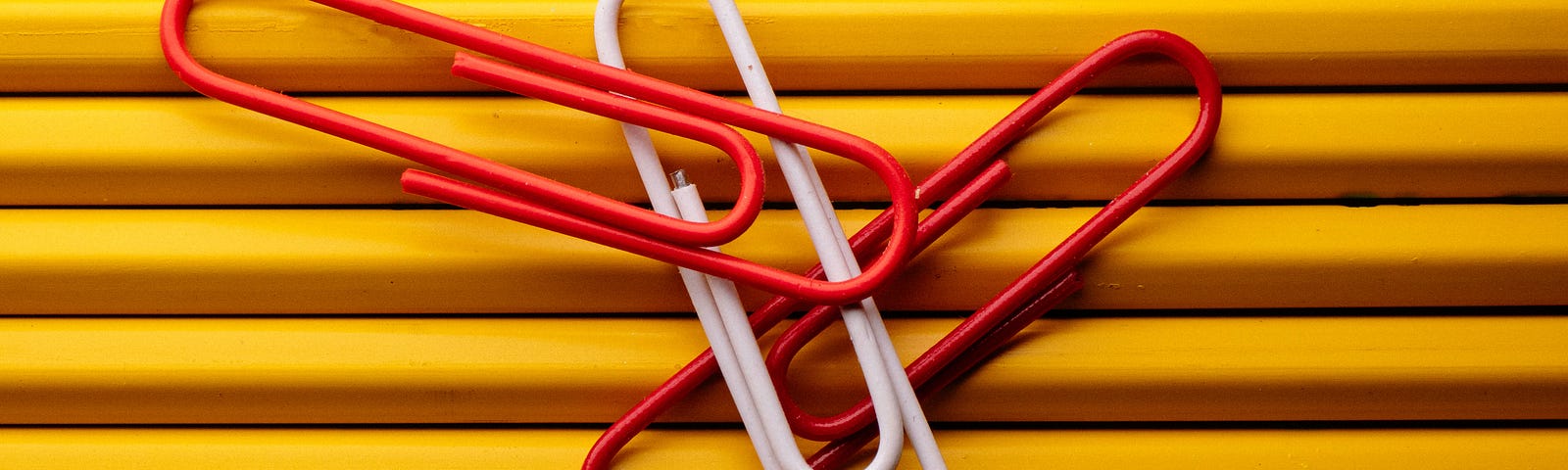 Paper clips resting on pencils.