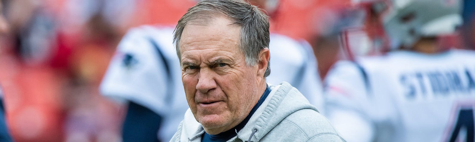 Photo of Coach Bill Belichick of New England Patriots NFL team walking around at practice in sweats