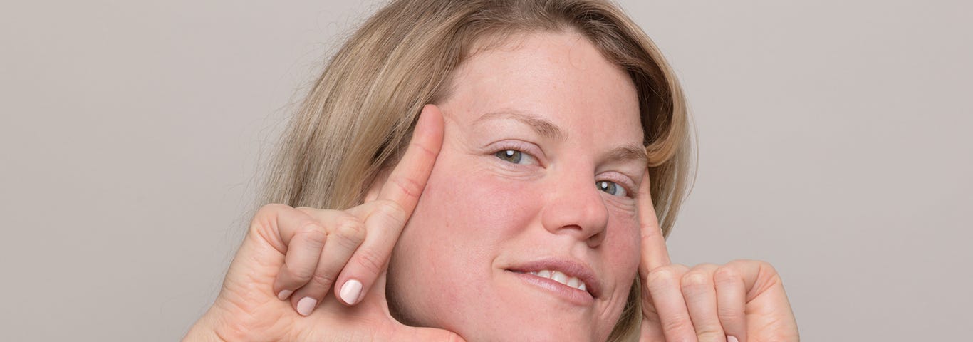 Woman frames her face, demonstrating how to determine your skin type.