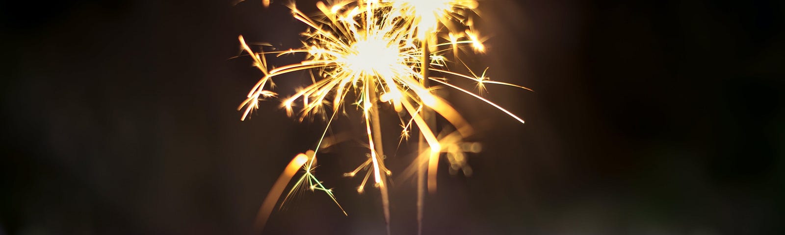 Person holding lighted sparkler