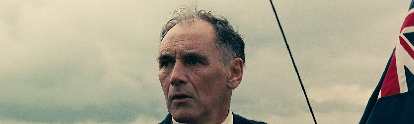 A photo of Mr. Rylance looking out over the ocean from the 2017 film Dunkirk.