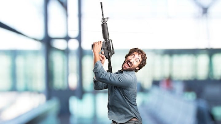 Photo of man shooting gun in the air. Satire. Humor. Guns. Ammo. Bullets. Revolutions. Soldiers. Coup. Second Amendment.