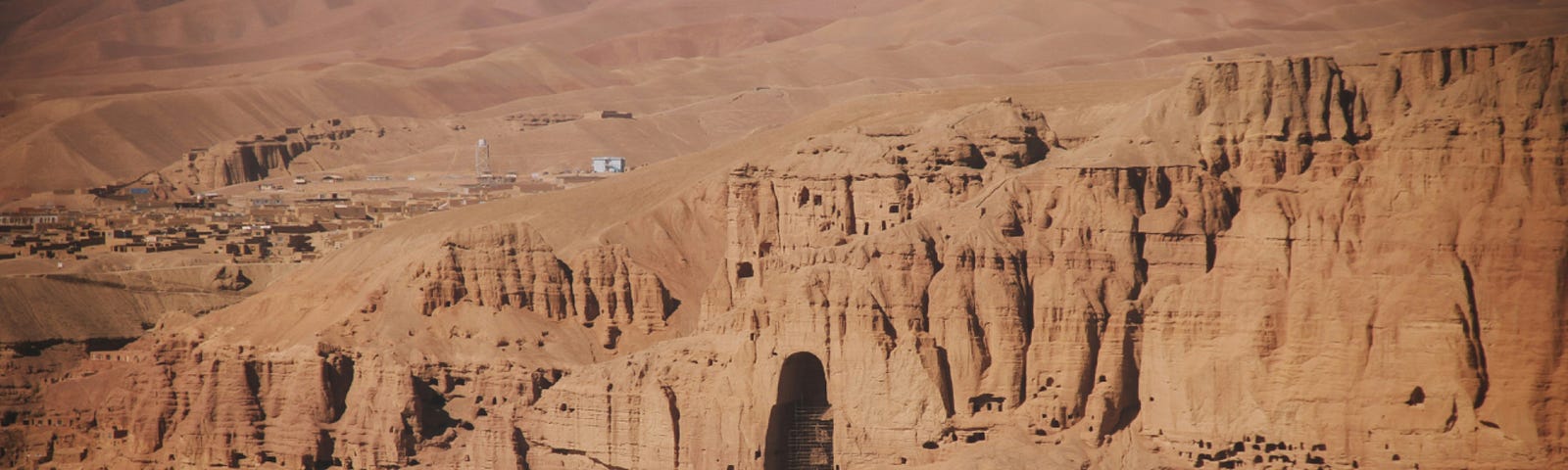 Desert mountains with a carved recess where a Buddha statue once was, Bamiyan Valley, Afghanistan