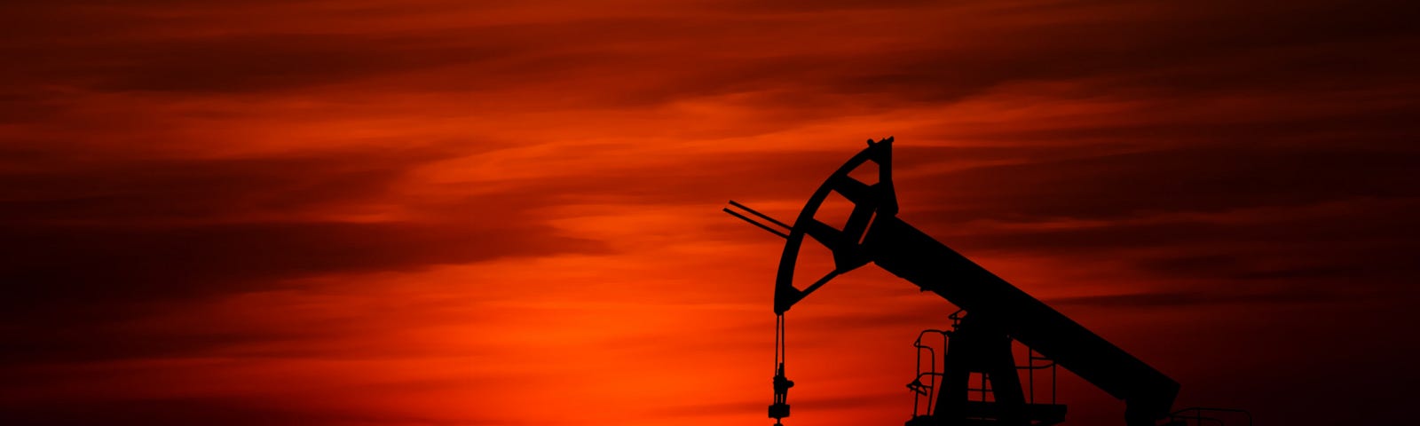 oil derrick at sunset