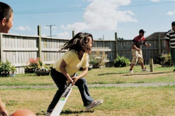Backyard cricket being played