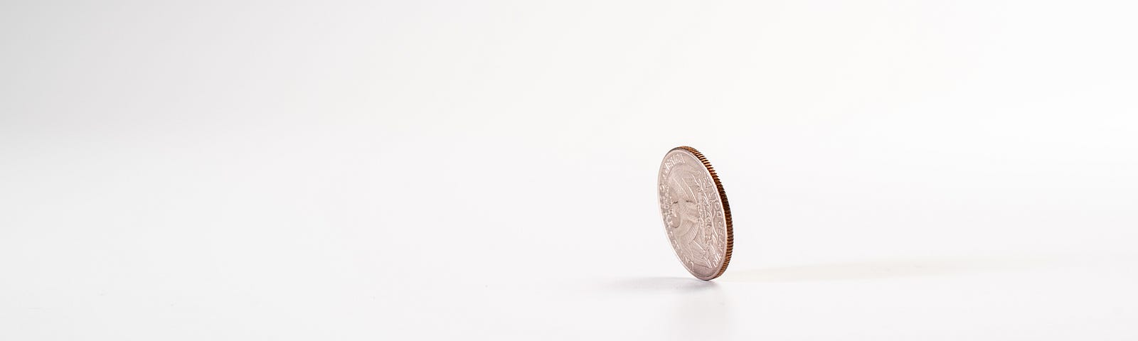 coin sitting on edge about to fall over