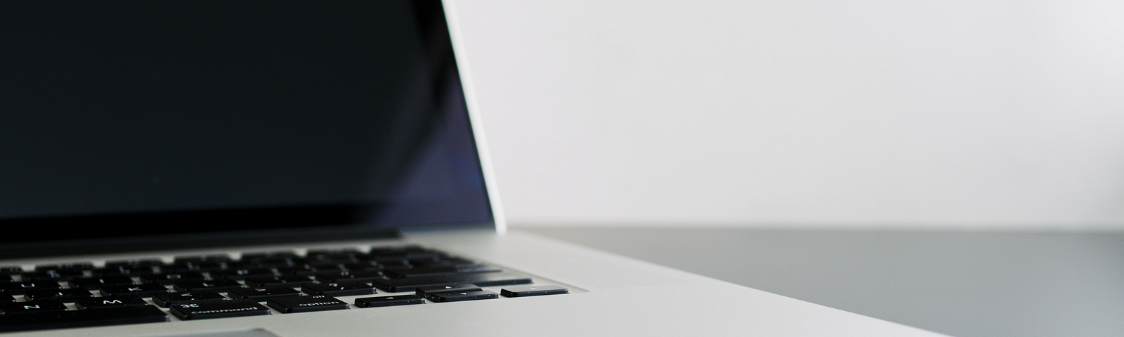 Close-up of an open laptop sitting on a desk.