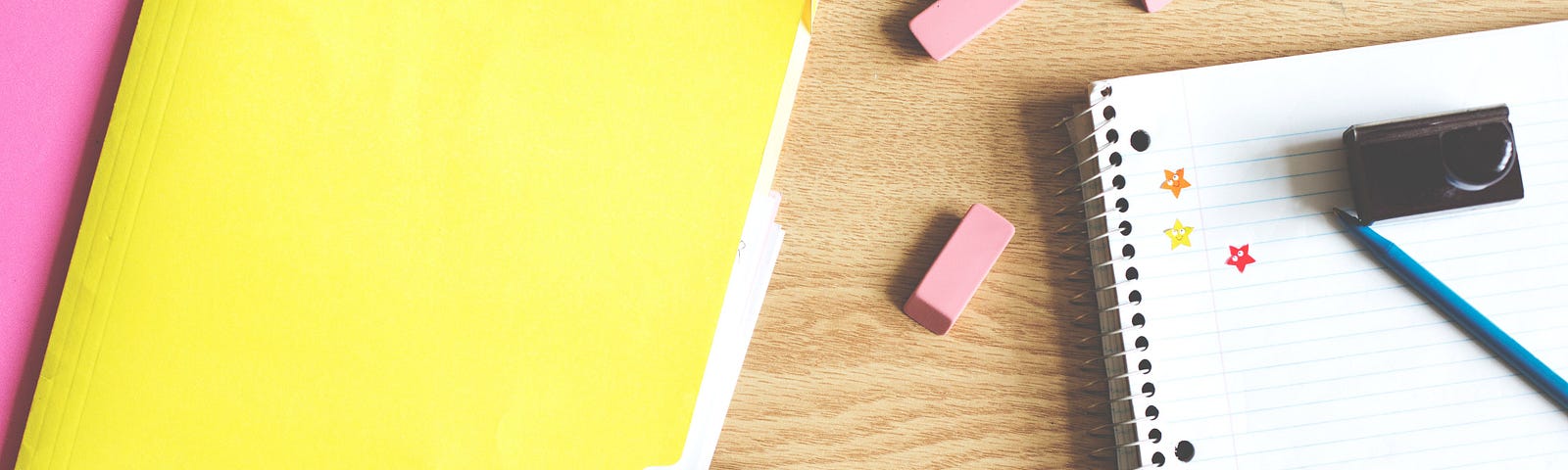 Photo of school suppllies on wooden table